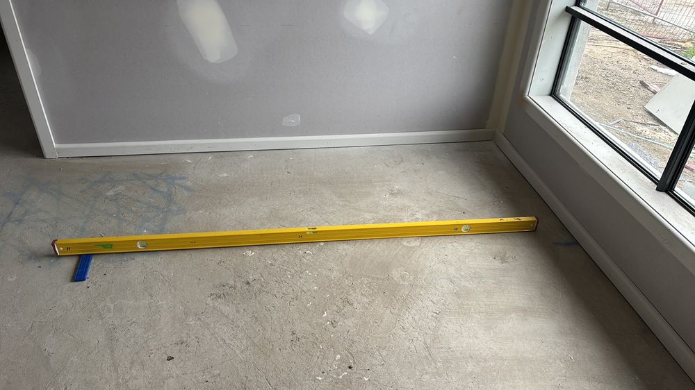 Floor slab out by more than the 10mm allowed within a room, Beveridge