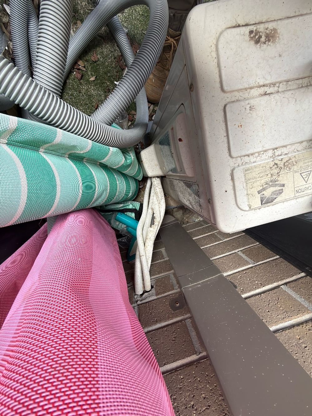 Air conditioner condensate dripping onto the ground against the wall, Doreen, Beveridge