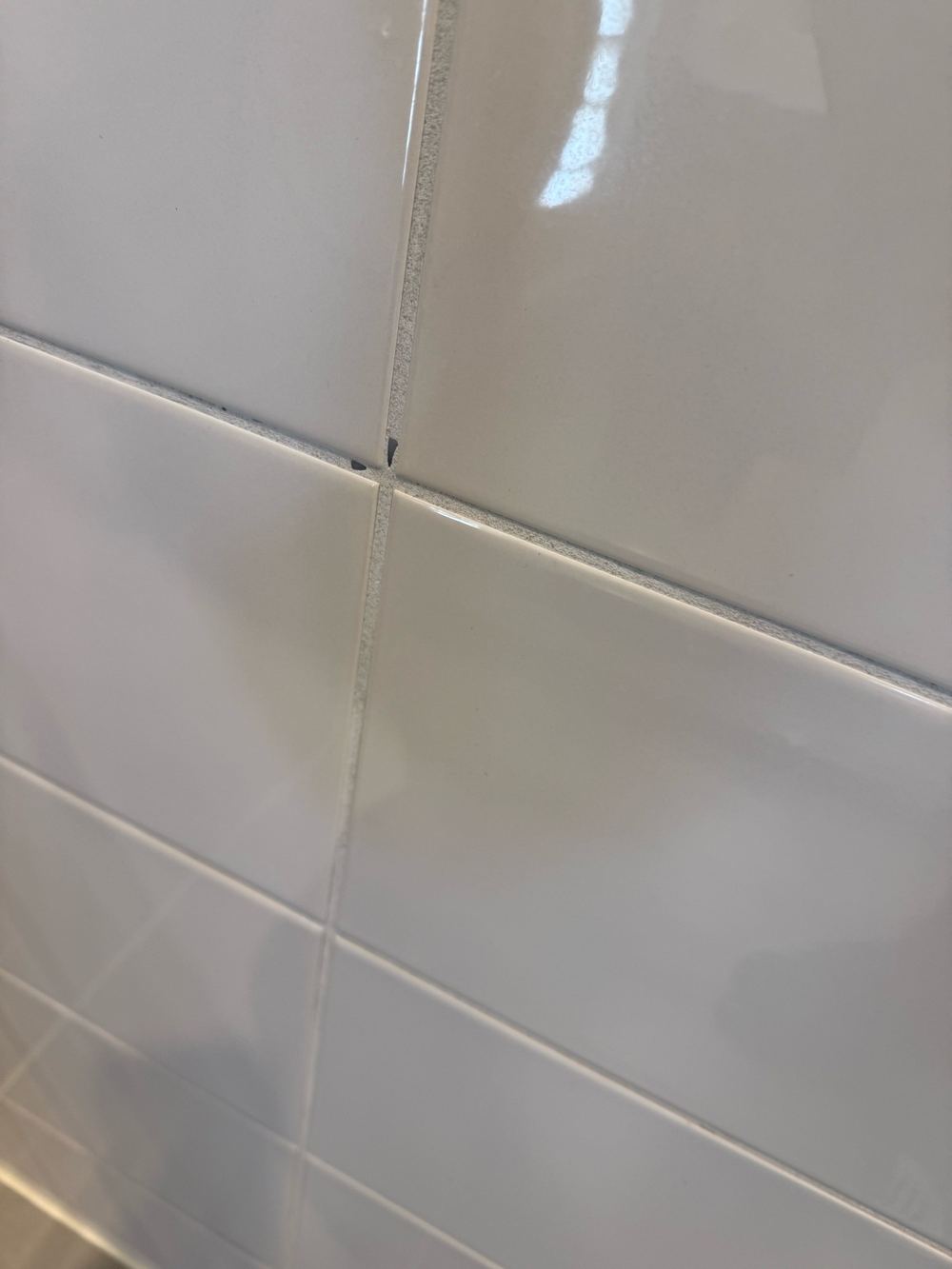 Worn tile grout in a wet area that will let water behind the tiles, found during a pre-purchase inspection in Doreen