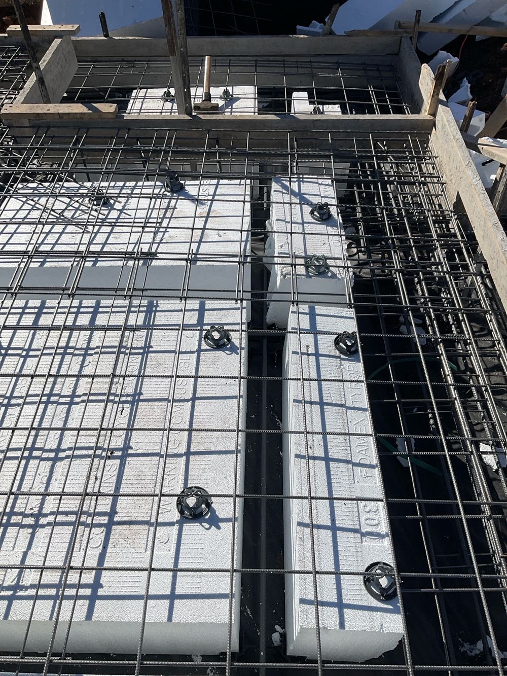 Slab beam narrowing where pods had shifted or spacers were never placed, found during a slab pre-pour inspection in Beveridge
