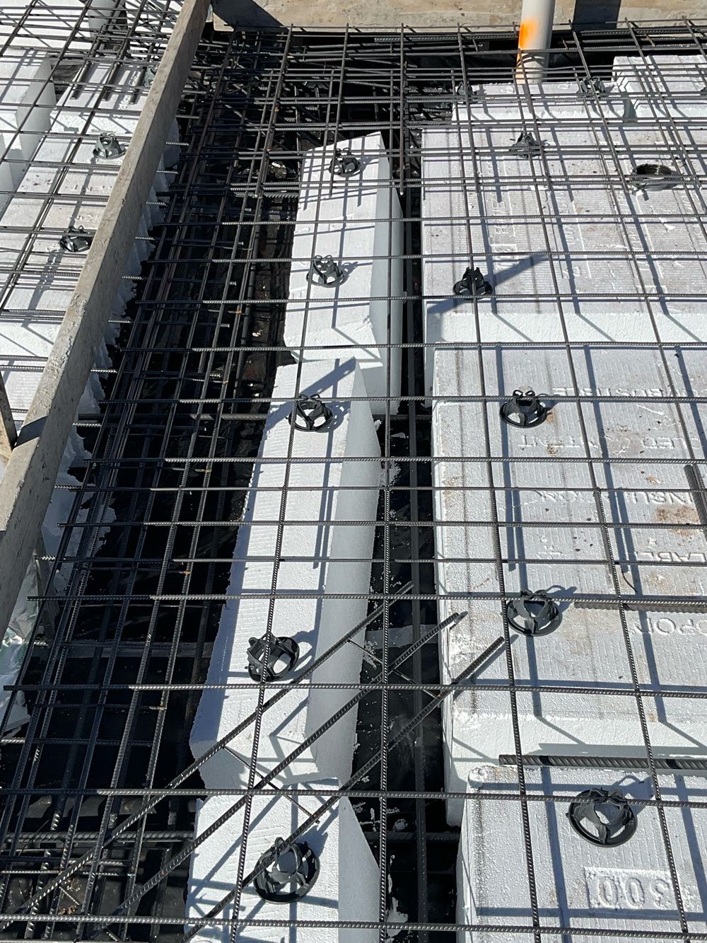A Beveridge slab beam squeezed by its own waffle pods