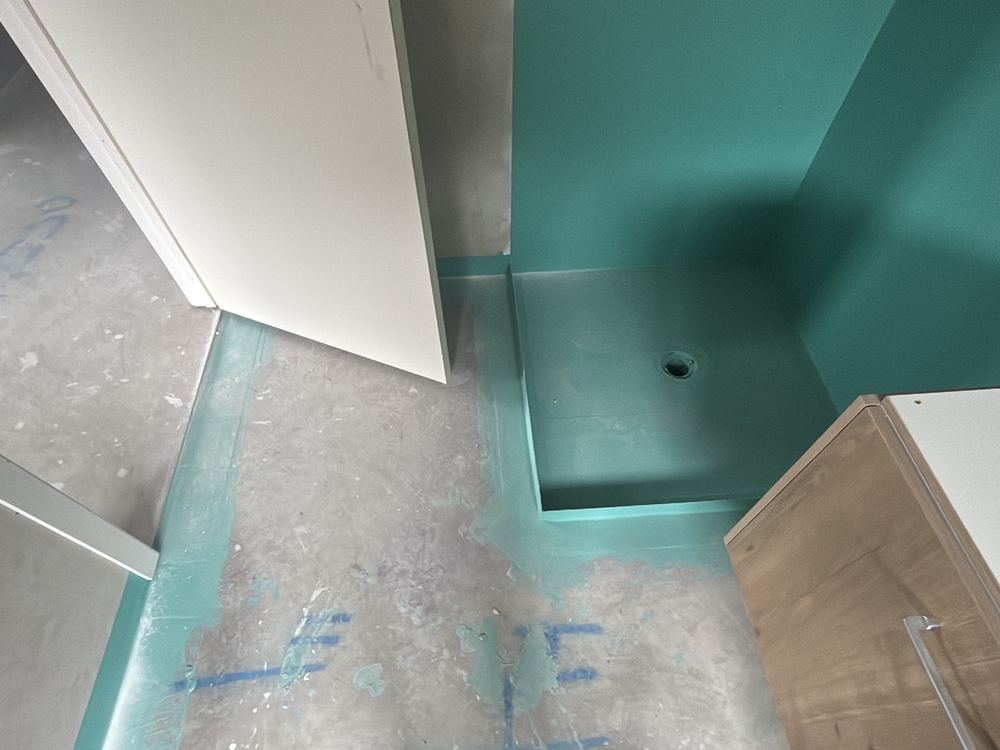 Fresh membrane left unprotected while other trades worked in the room, found during a waterproofing inspection in Beveridge